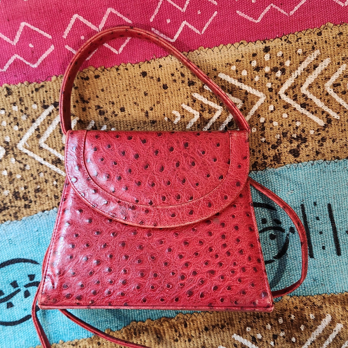 Top-down front view of vintage Mike's Collection red ostrich-embossed leather mini handbag