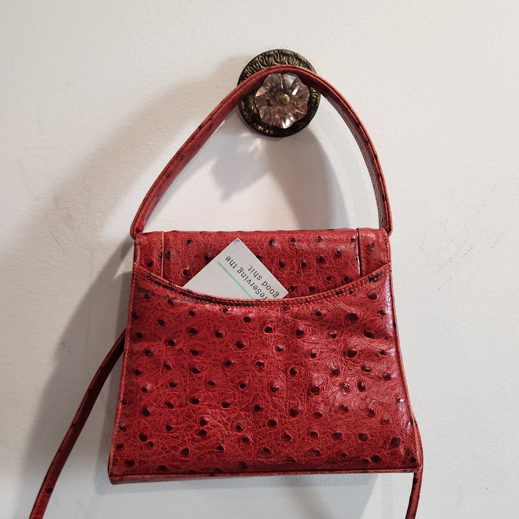 Close-up of the back slip pocket of vintage Mike's Collection red ostrich-embossed leather mini handbag, showing ostrich-embossed texture