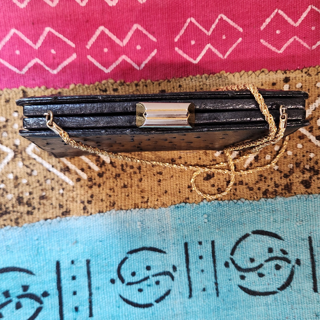 Interior of vintage Beoni Lucia black evening bag, showing black lining, slip pocket and gold oval Beoni Lucia designer plaque
