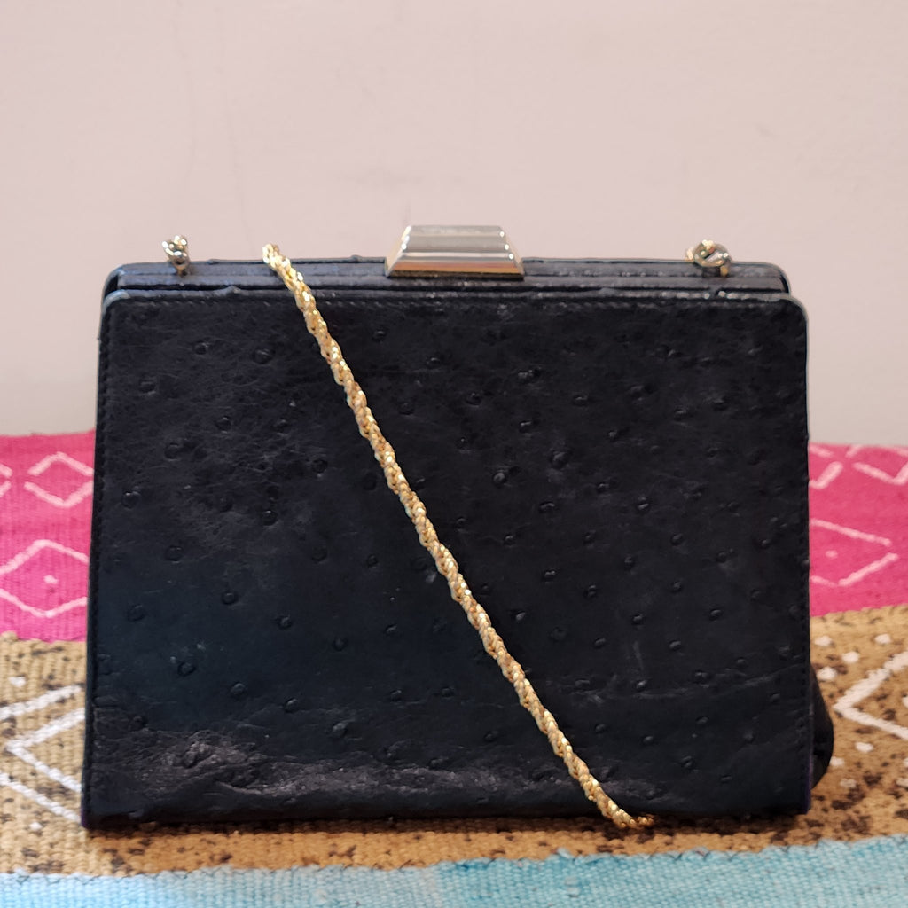 Close-up of the gold oval Beoni Lucia designer plaque inside the evening bag, reading Beoni Lucia LB Made in Italy