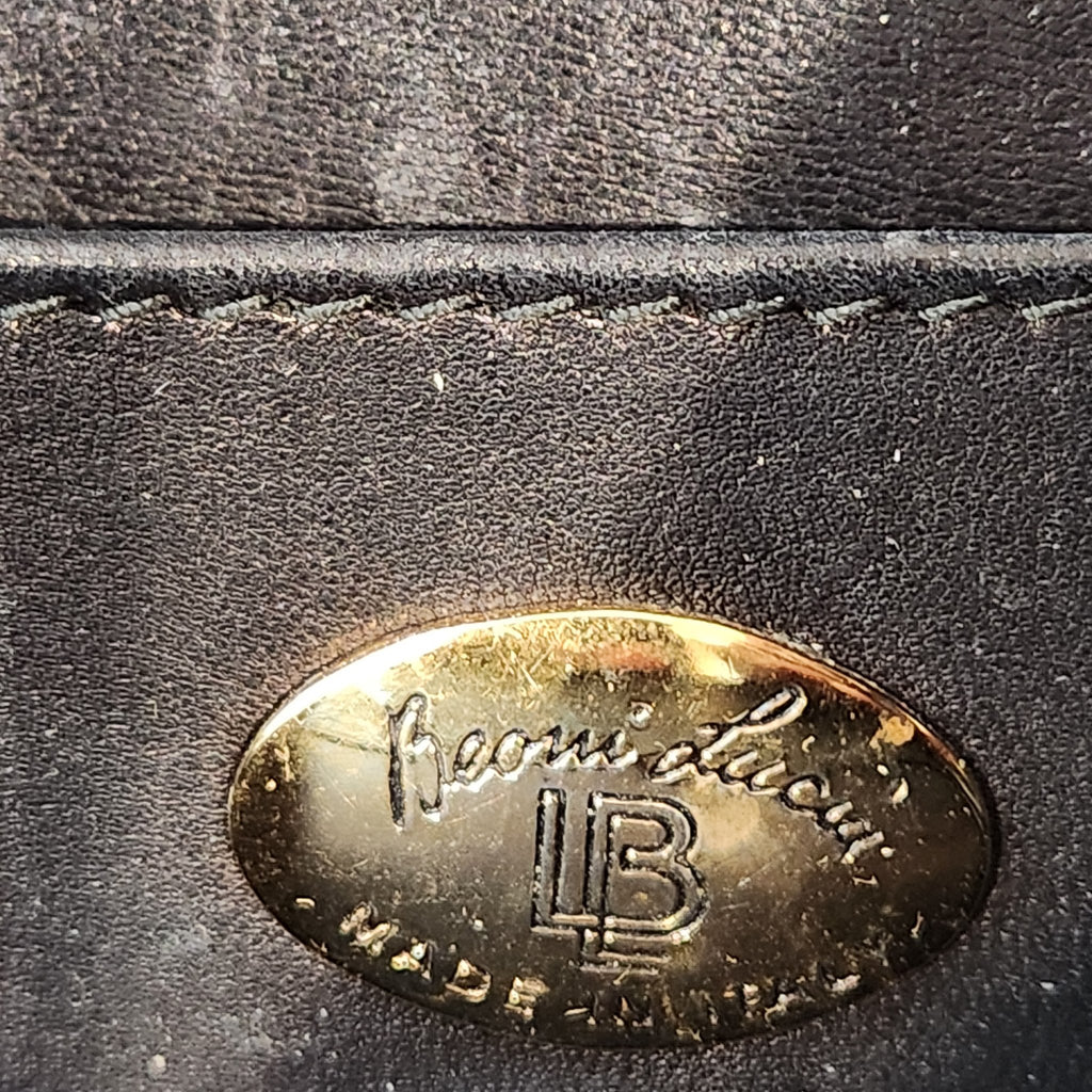 Detailed close-up of the gold oval Beoni Lucia designer plaque, showing script lettering and LB monogram