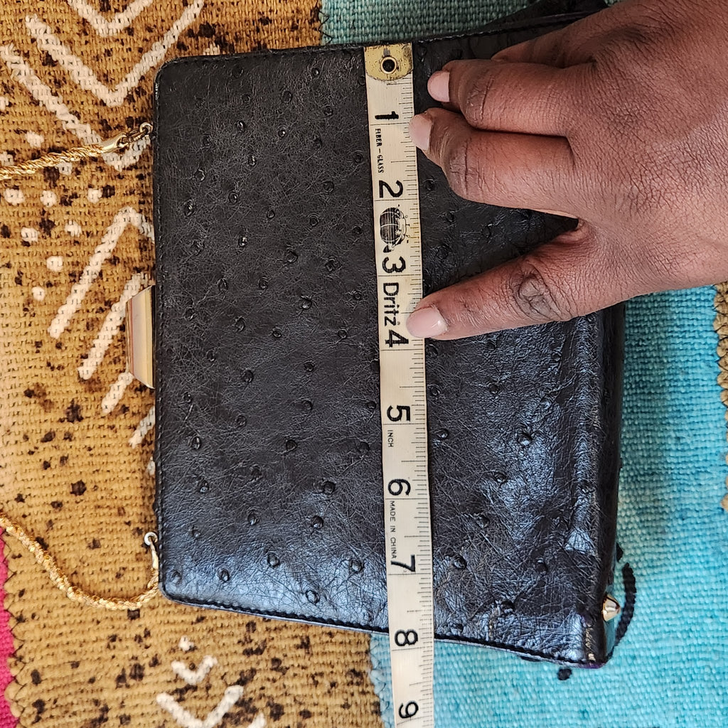 Width measurement of vintage Beoni Lucia black evening bag, tape measure showing approximately 8 inches