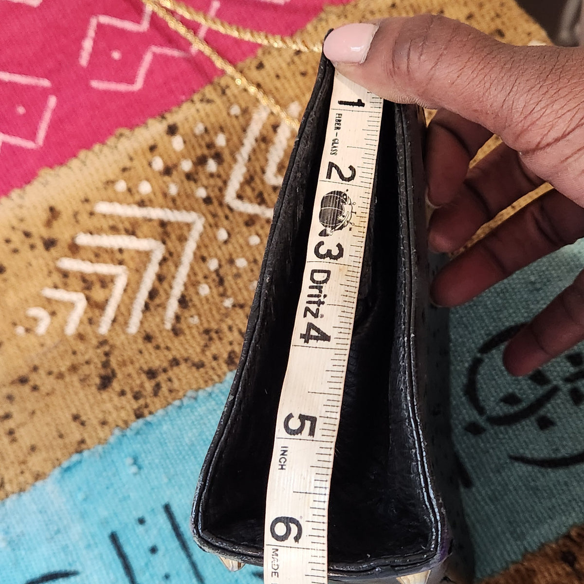 Side gusset height measurement of vintage Beoni Lucia black evening bag, tape measure showing approximately 6 inches