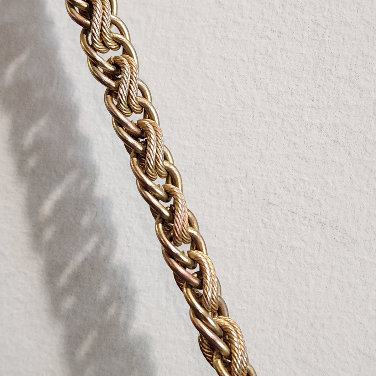 Original photo: close-up of the intricately linked gold-tone chain