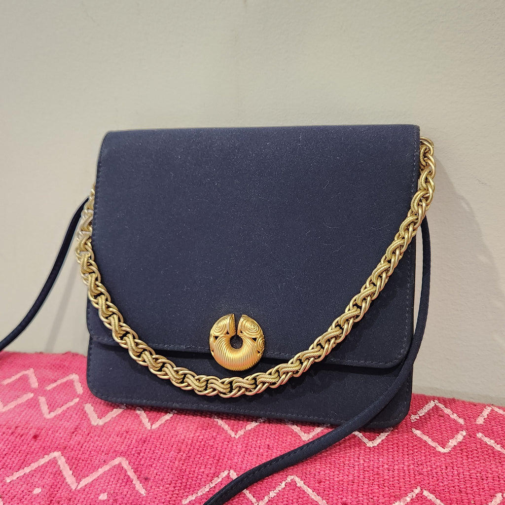 Original photo: vintage Kenneth Jay Lane midnight navy flap bag with gold chain draped across the front, closer view