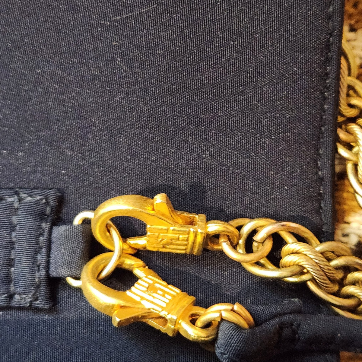 Original photo: close-up of the gold-tone chain clasps