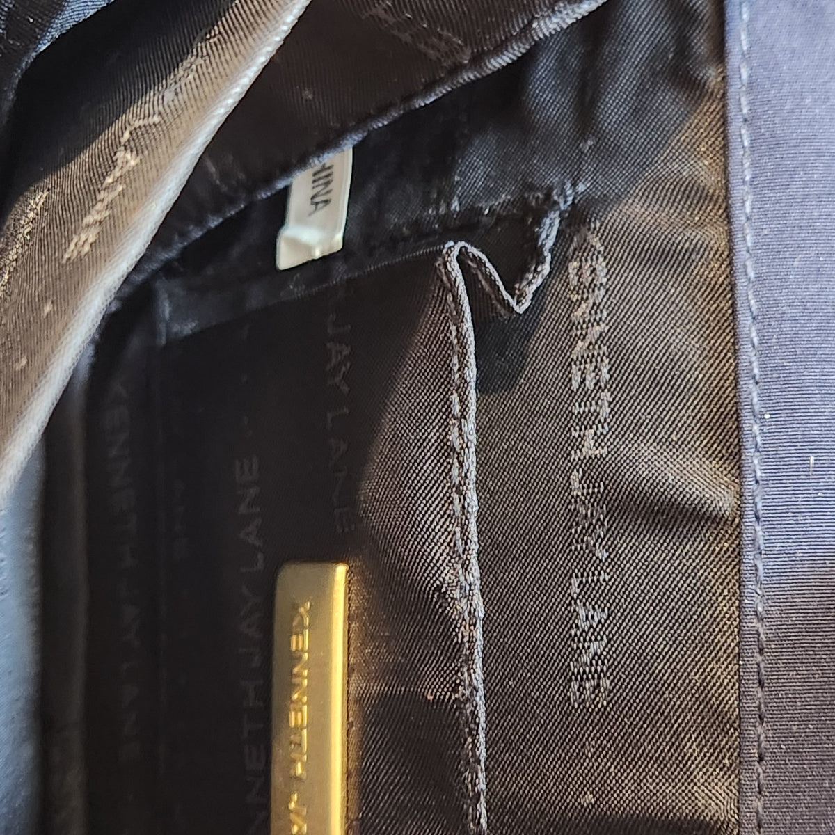 Original photo: interior of the bag showing the Kenneth Jay Lane branded lining and gold designer plaque
