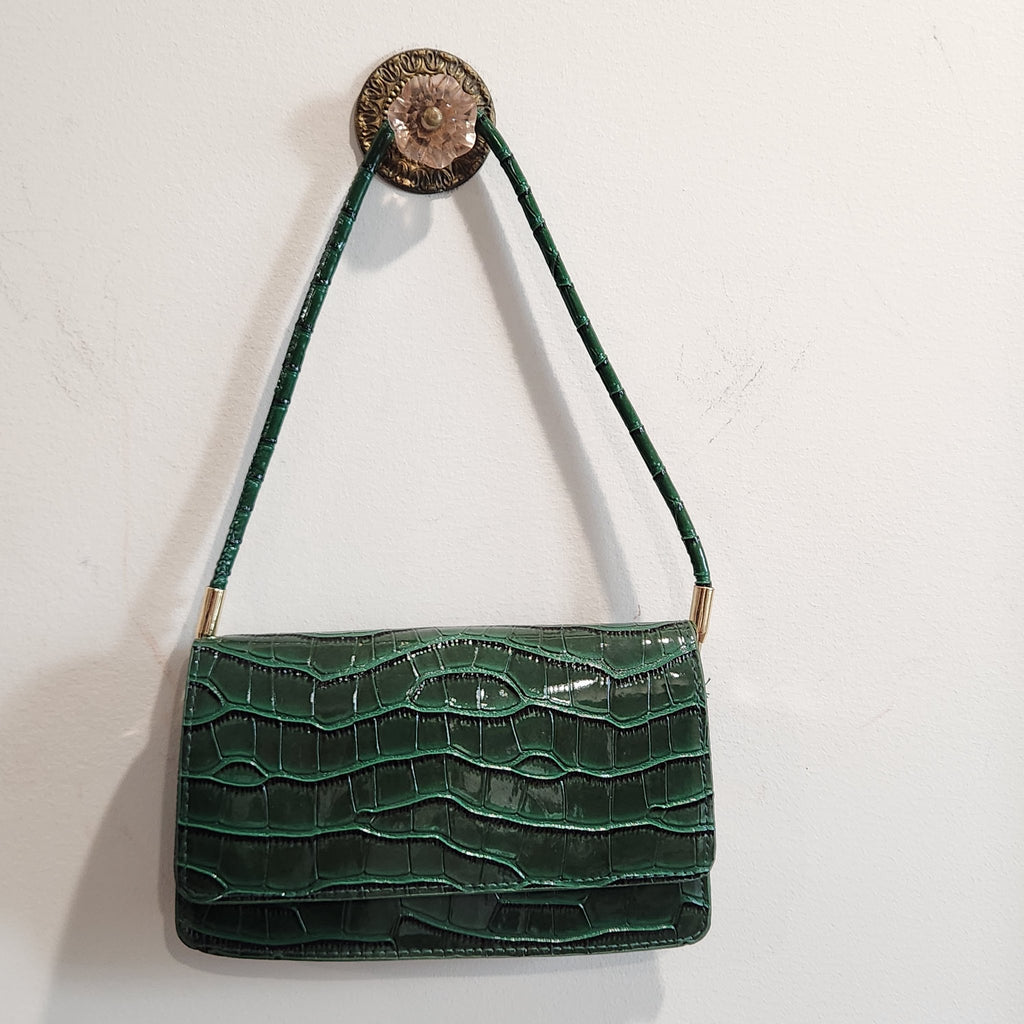 Forest green croc-embossed shoulder bag hanging, front view