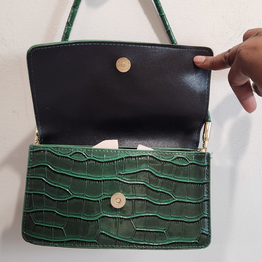 Flap open showing the black interior lining and gold-tone magnetic snap closure