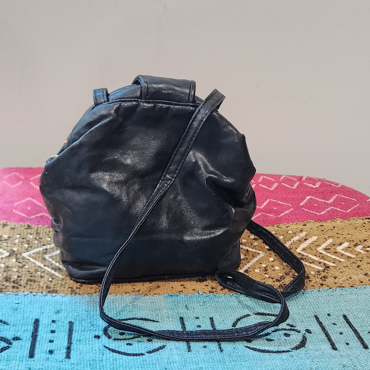 Original photo: back view of the black embellished bucket shoulder bag, plain black leather-look exterior