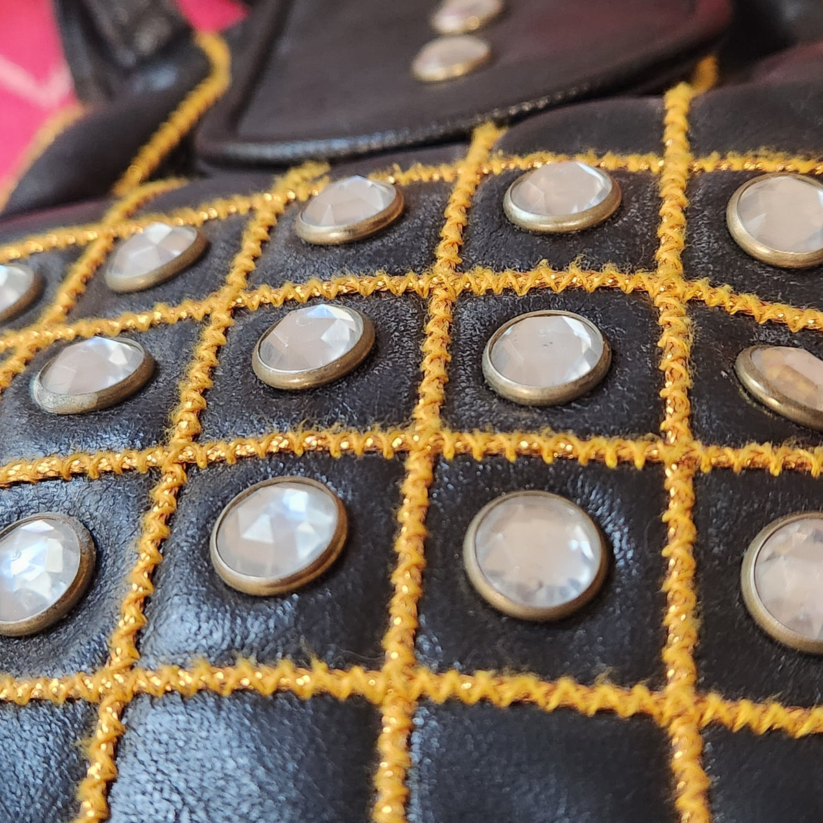 Original photo: close-up of the golden grid embroidery and faceted crystal-style studs