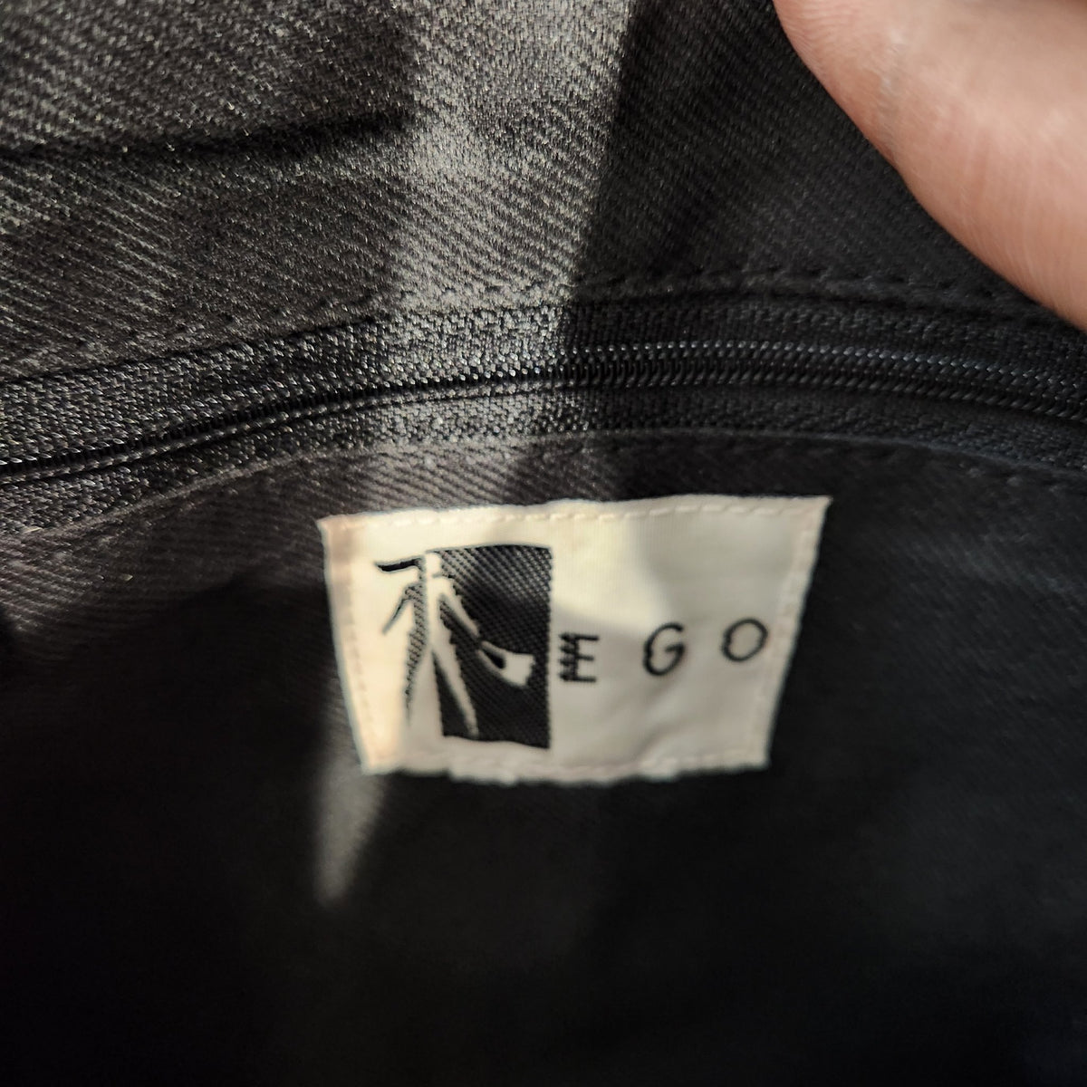 Original photo: interior EGO brand label inside the vintage black suede fringe bag
