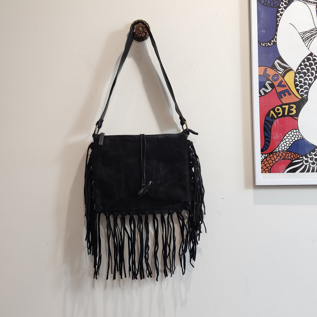 Original photo: vintage EGO black suede fringe shoulder bag hanging on a wall hook, front view