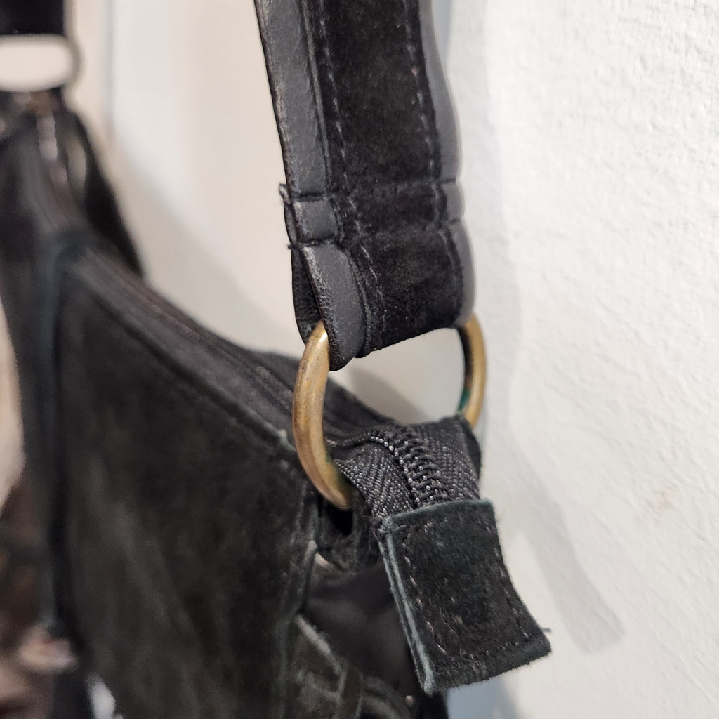 Original photo: close-up of the antique-tone ring hardware where the strap meets the bag body
