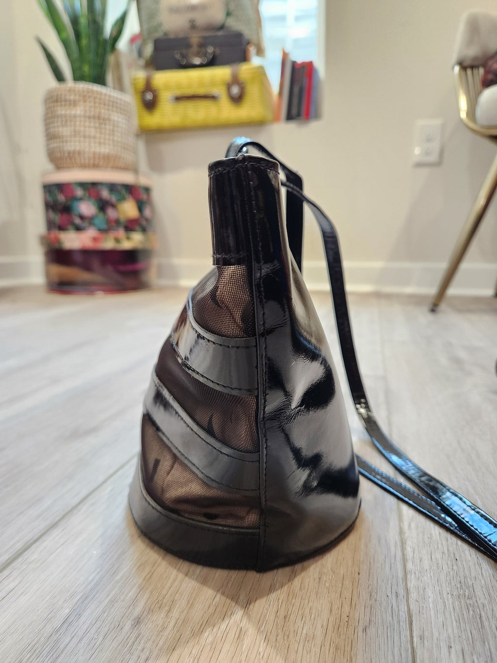 Side profile of vintage Linda Allard for Ellen Tracy black patent leather and sheer mesh bucket bag