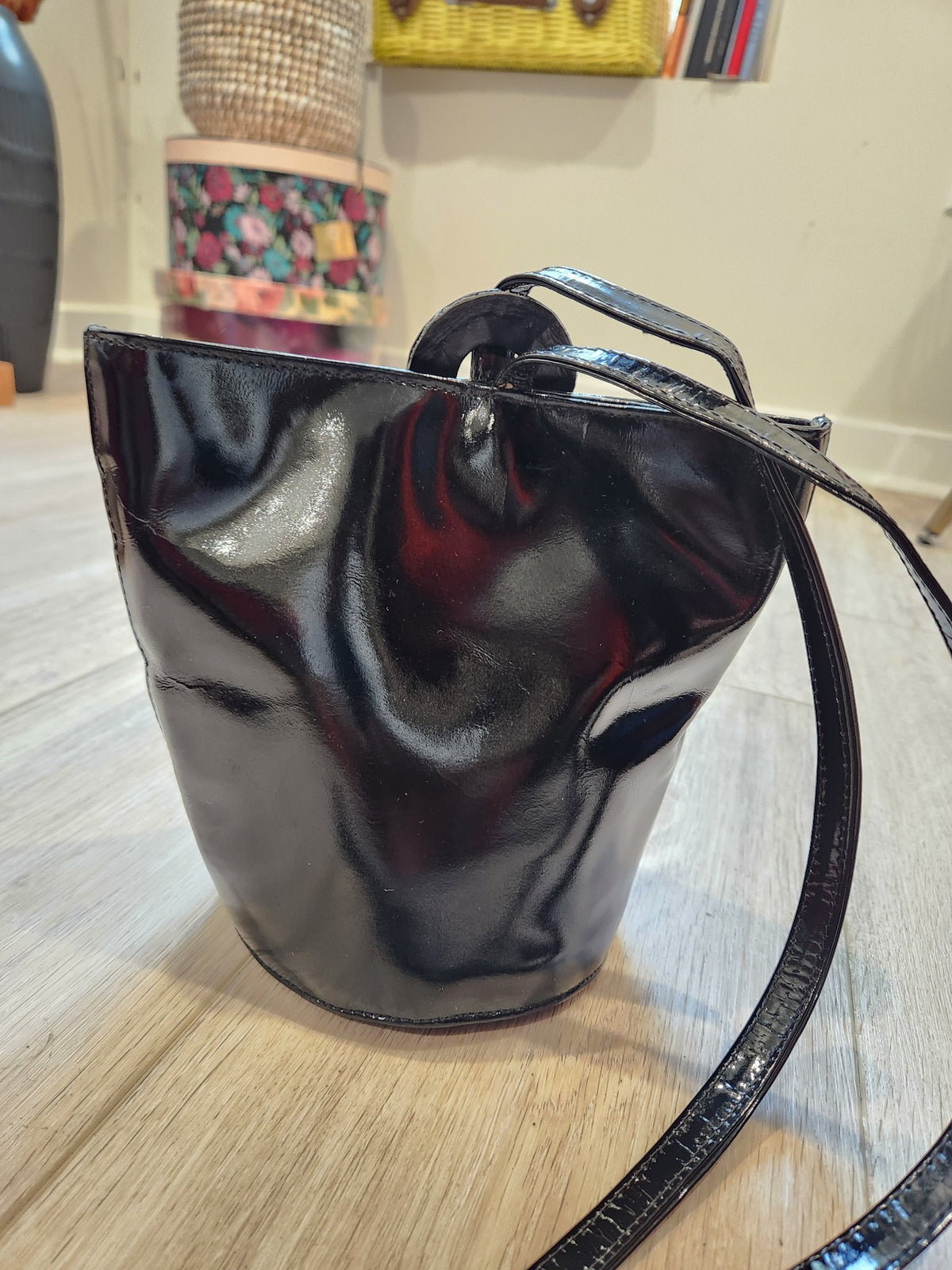Back view of vintage Linda Allard for Ellen Tracy bucket bag in solid black patent leather