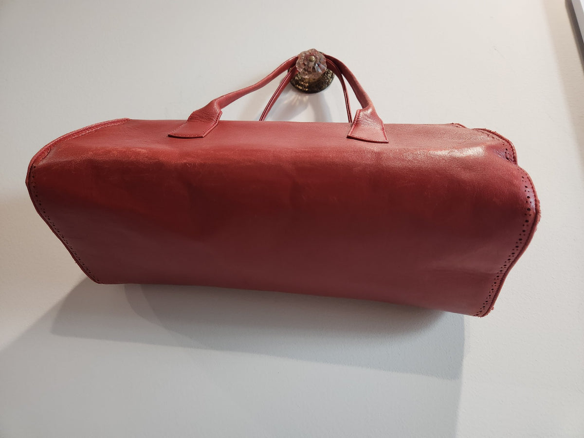 Back and underside view of vintage Robinson Valentine brick-red leather barrel shoulder bag