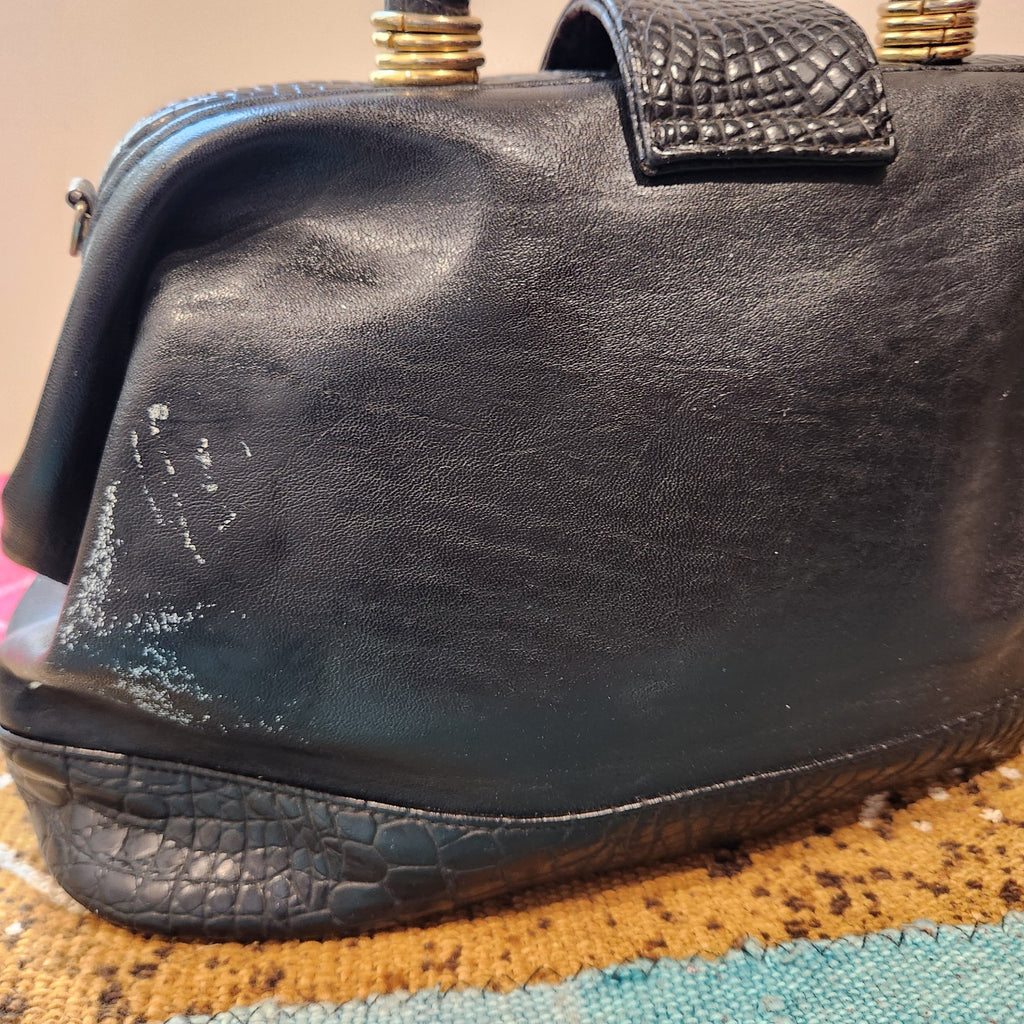 LaTique handbag side showing white scuff and finish loss