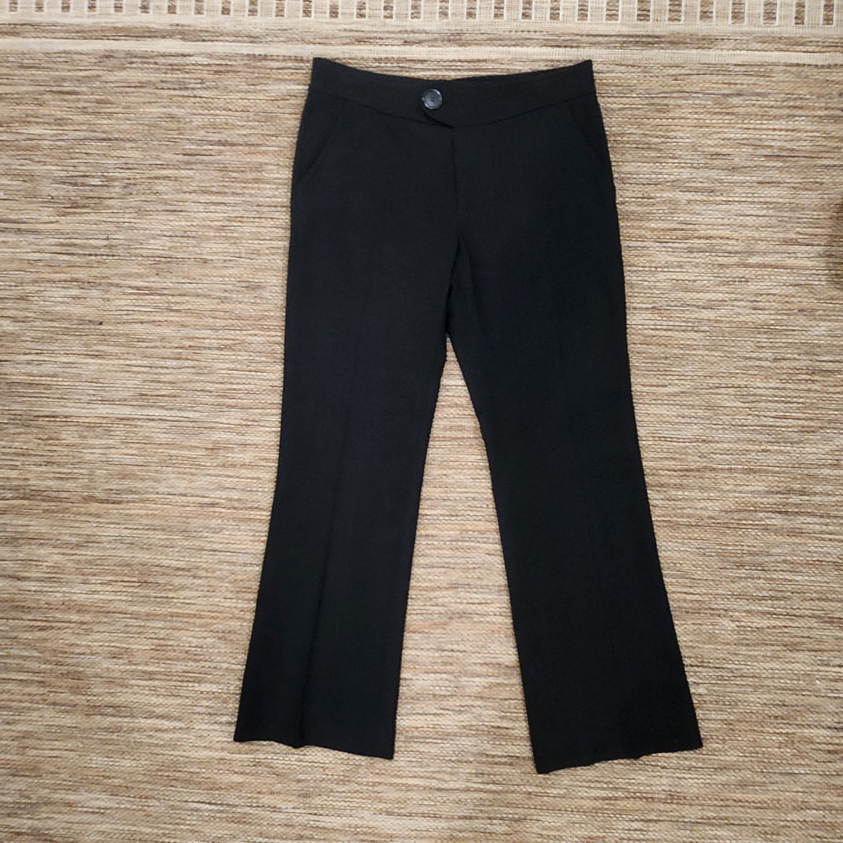 Lucille Golden Vintage, LLC black wool dress trousers with a tailored fit and minimalist front design.