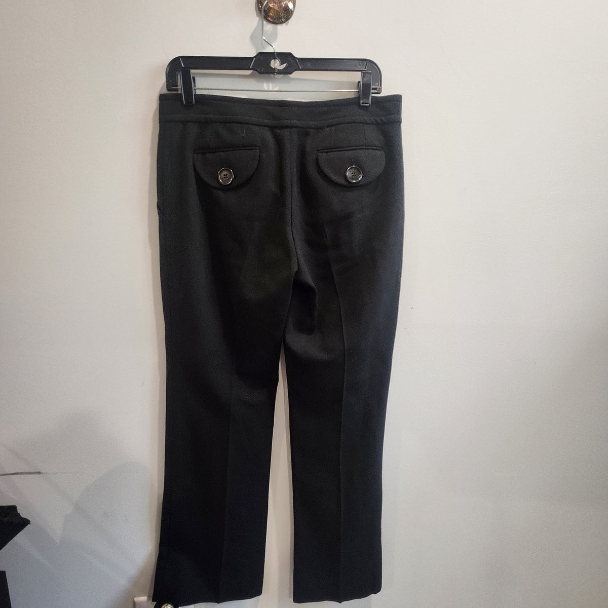 Lucille Golden Vintage, LLC black wool trousers with button-flap back pockets and a tailored fit.