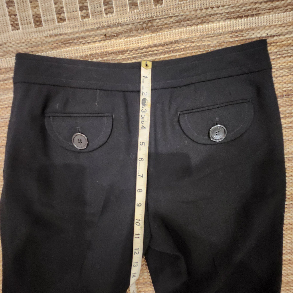 Lucille Golden Vintage, LLC black wool trousers with button-flap back pockets and measuring tape for size reference