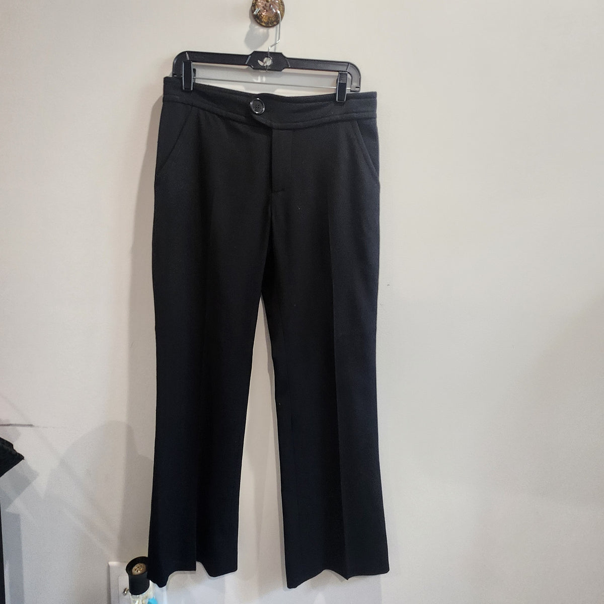 Lucille Golden Vintage, LLC black wool tailored trousers with a clean front and structured fit hanging on a hanger.