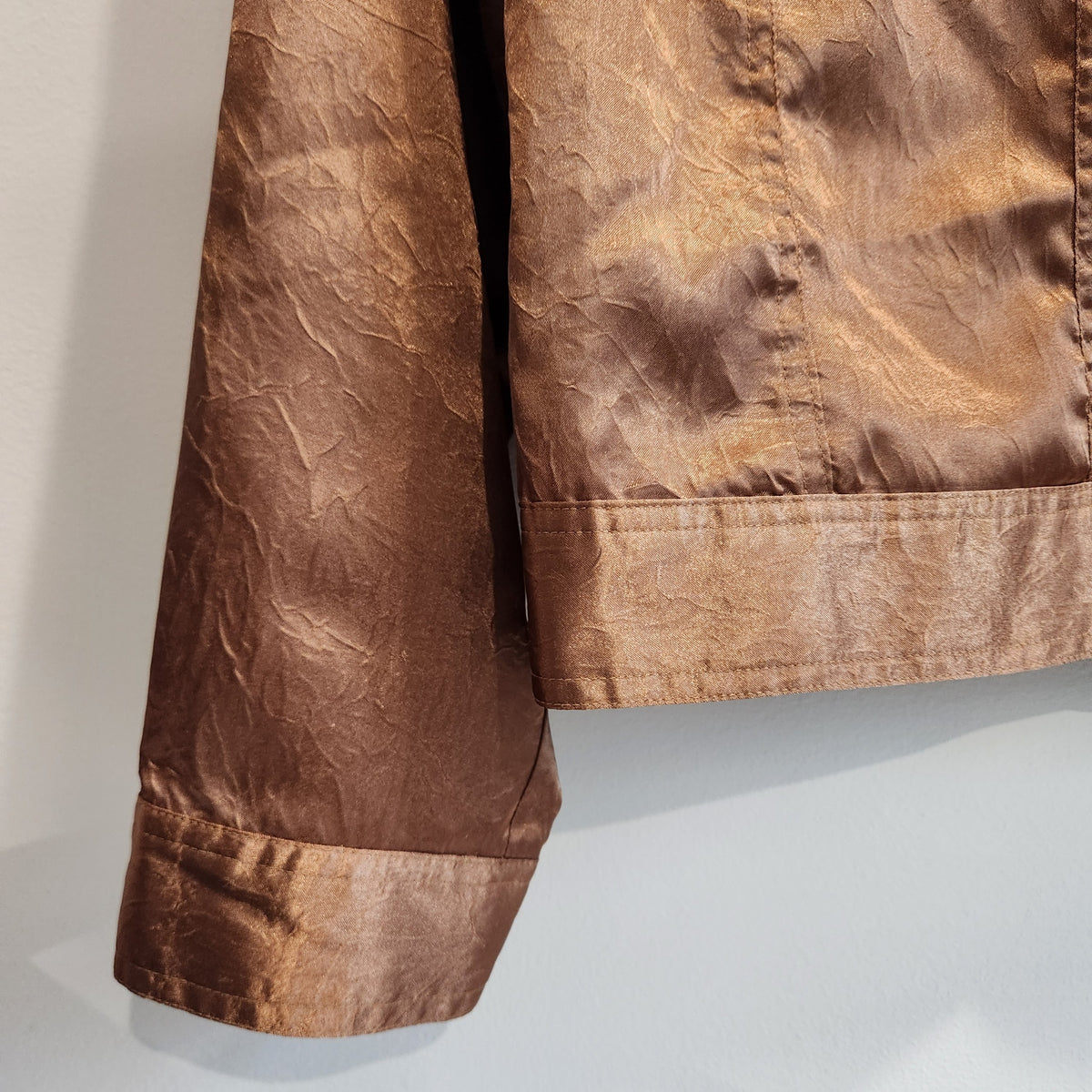 Lucille Golden Vintage, LLC metallic bronze jacket with a crinkled texture and structured hem detail.