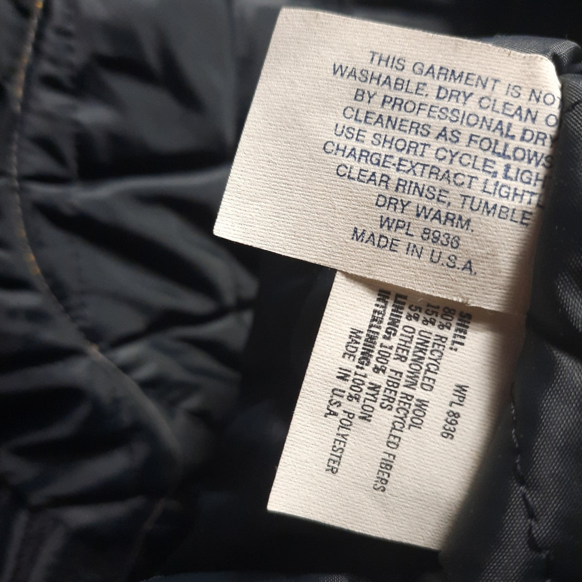 Lucille Golden Vintage, LLC interior care and material label of a 1990s DeLong varsity jacket made in the USA.