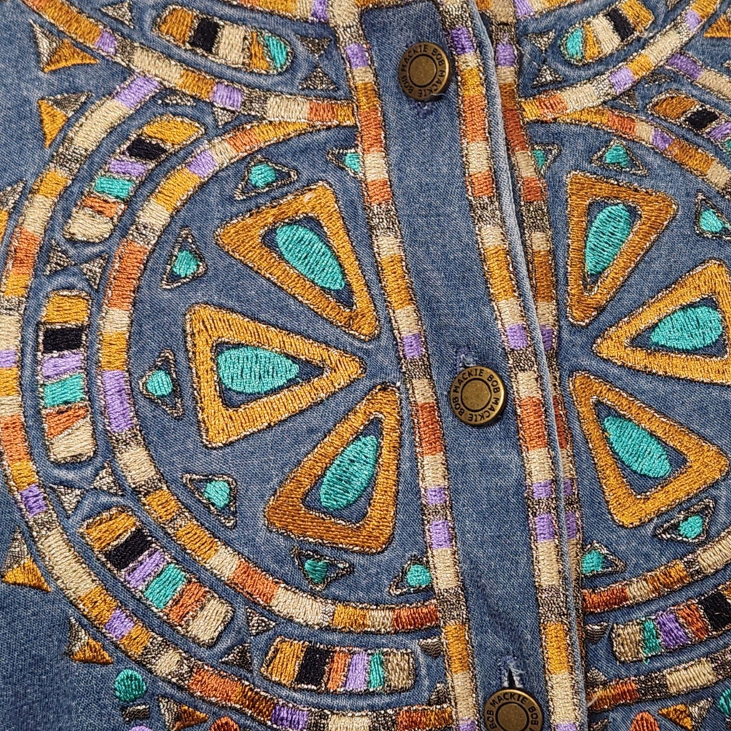 Lucille Golden Vintage, LLC denim shirt featuring intricate turquoise, gold, and purple geometric embroidery detail.