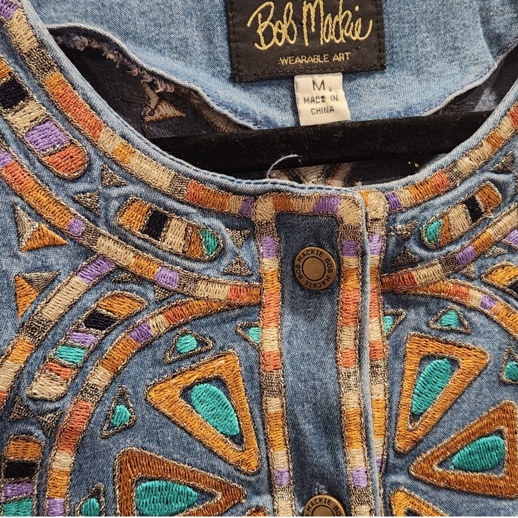 Lucille Golden Vintage, LLC Bob Mackie denim shirt featuring intricate turquoise, gold, and purple geometric embroidery.