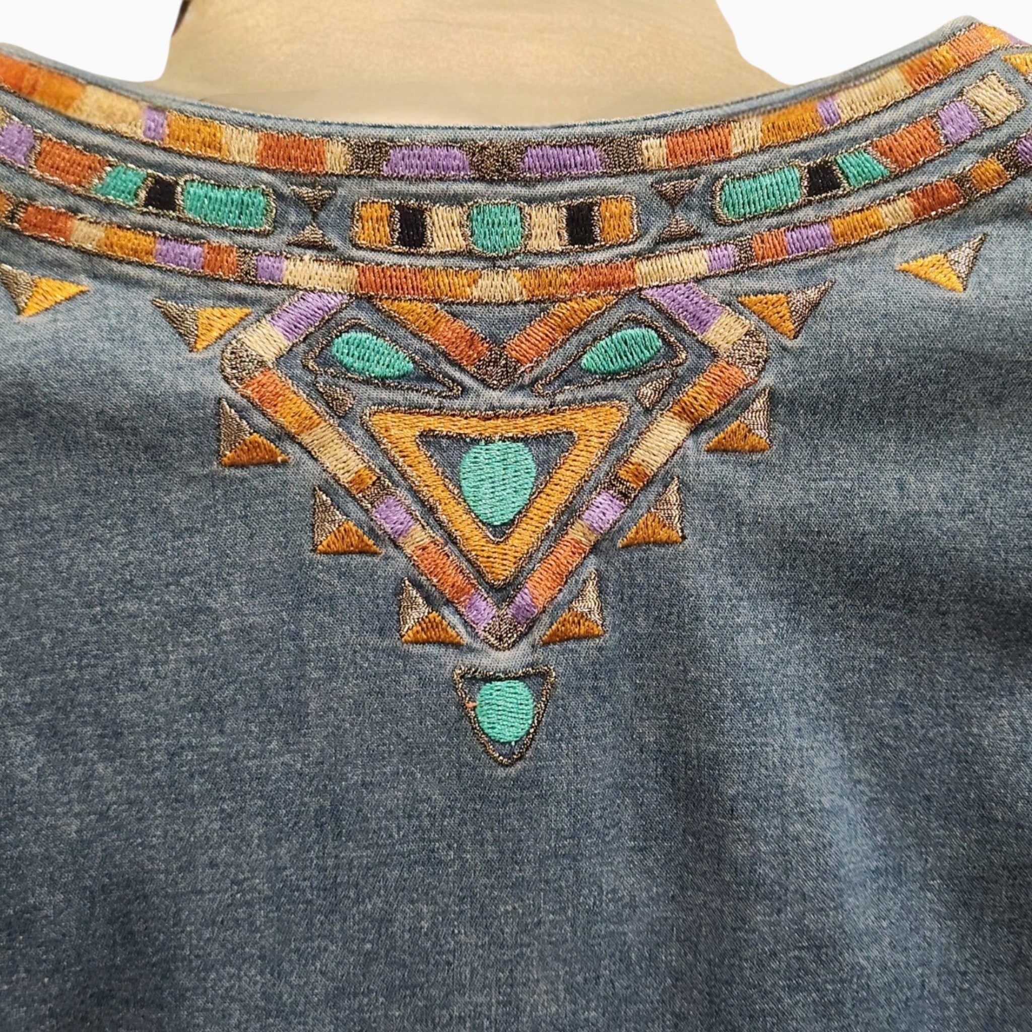 Lucille Golden Vintage, LLC Bob Mackie denim shirt featuring intricate turquoise, gold, and purple geometric embroidery.
