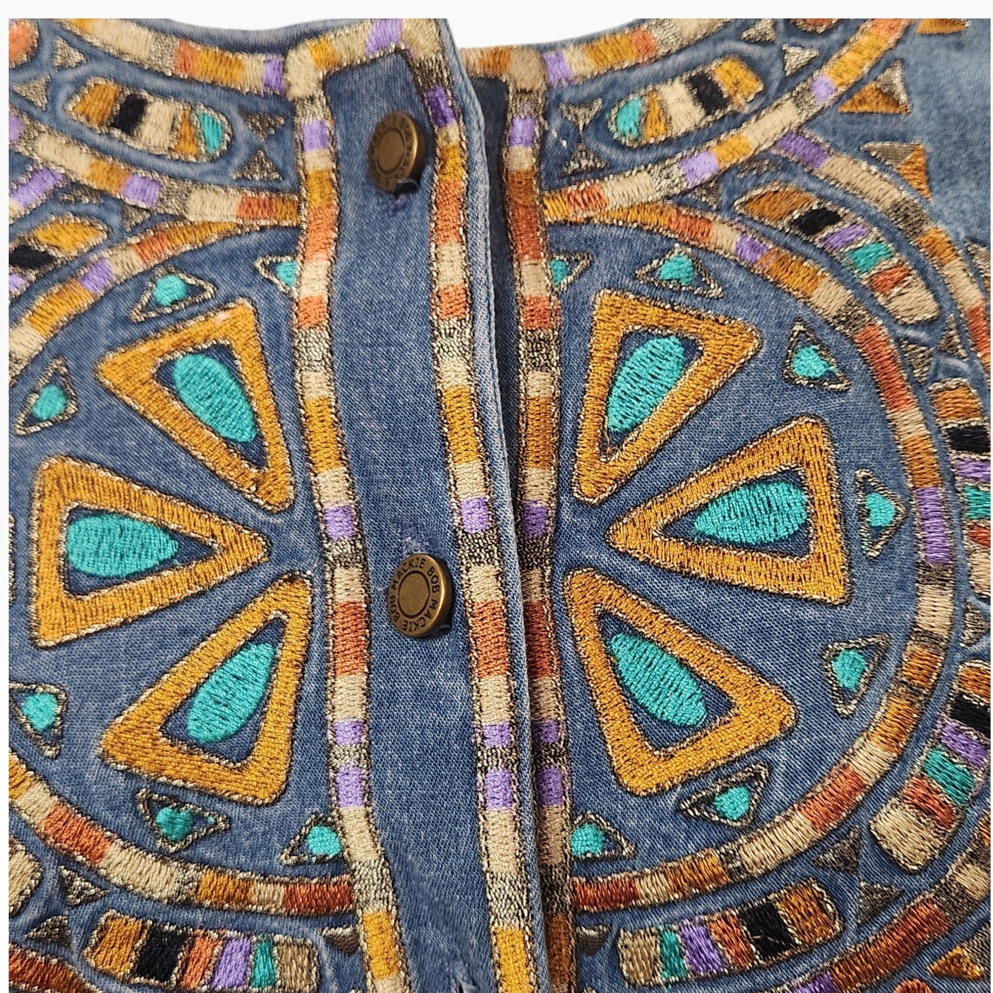 Lucille Golden Vintage, LLC Bob Mackie denim shirt featuring intricate turquoise, gold, and purple geometric embroidery.