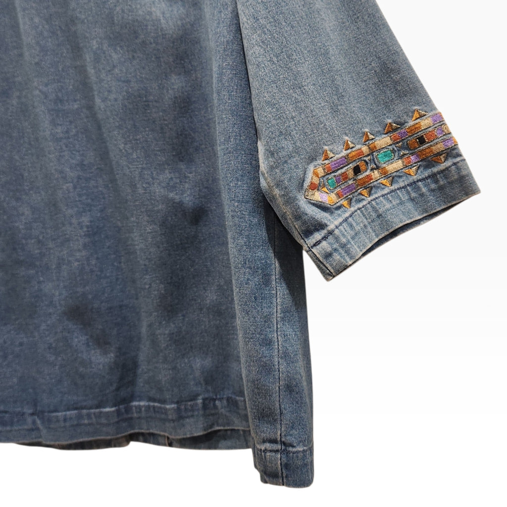 Lucille Golden Vintage, LLC denim shirt sleeve with intricate turquoise, gold, and purple geometric embroidery detail.