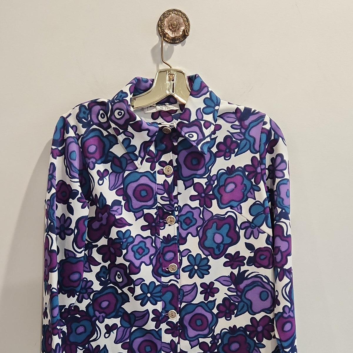 Lucille Golden Vintage, LLC long-sleeve button-down shirt with a vibrant purple, violet, and teal floral print.