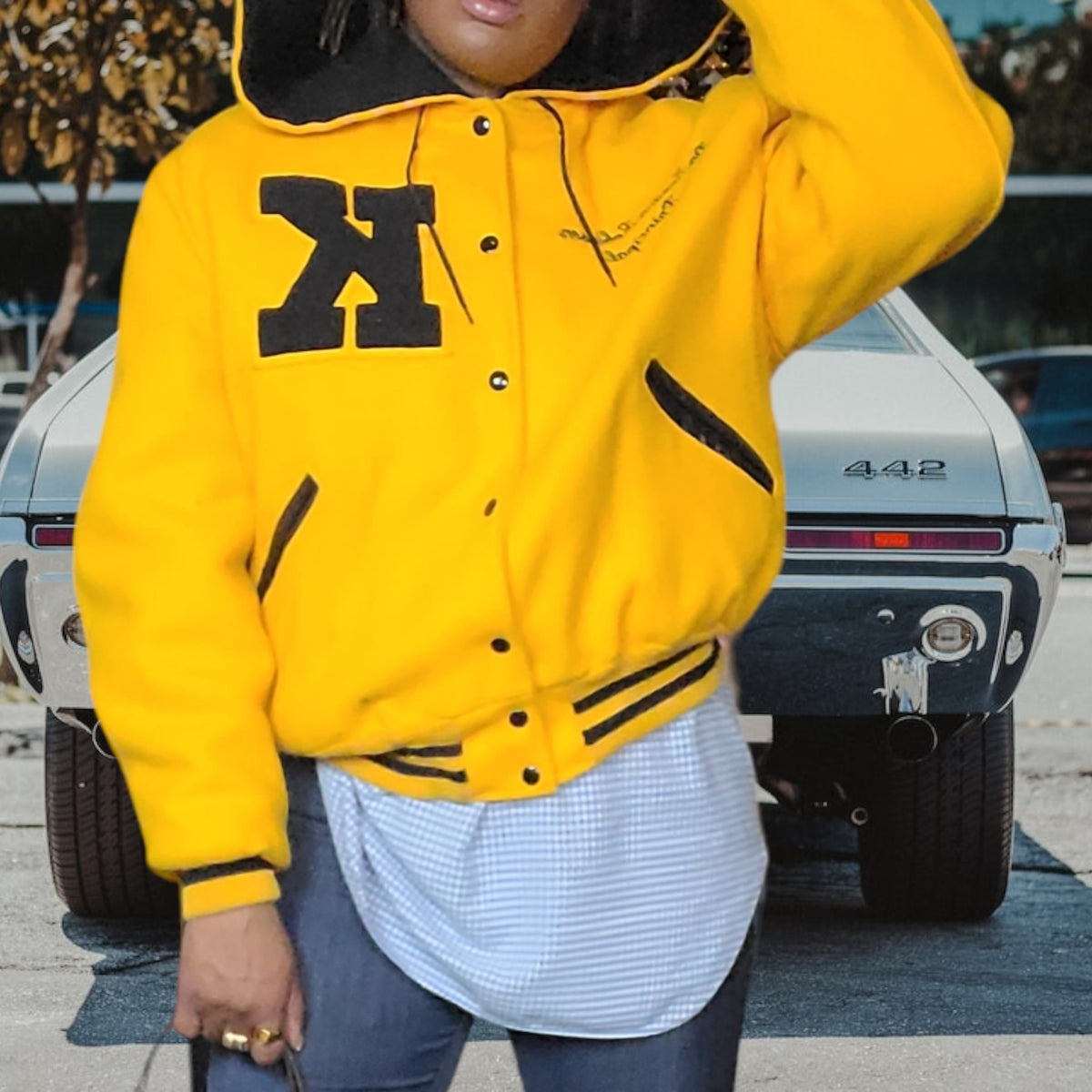 Lucille Golden Vintage, LLC 1990s gold and black wool varsity jacket with chenille K patch and oversized hood
