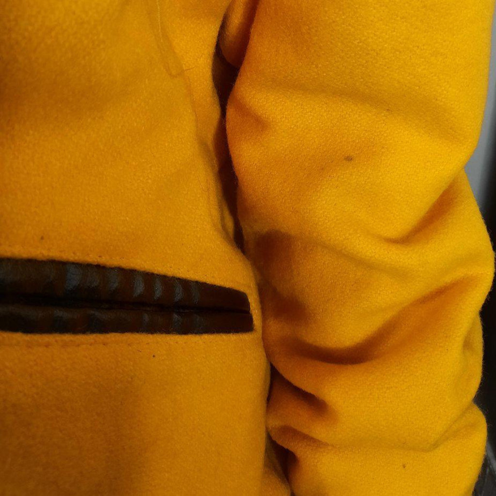 Lucille Golden Vintage, LLC gold wool varsity jacket sleeve detail showing leather pocket trim and vintage texture