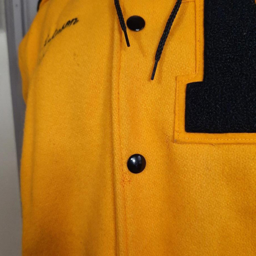 Lucille Golden Vintage, LLC 1990s gold wool varsity jacket with black snap buttons and chenille K patch