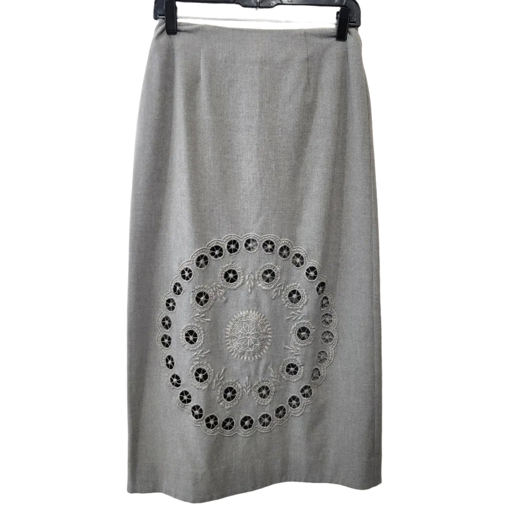 Lucille Golden Vintage, LLC grey midi skirt featuring intricate circular laser-cut embroidery on a tailored silhouette.