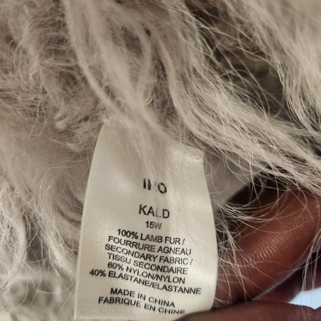 Lucille Golden Vintage, LLC IRO Kald jacket care label showing 100% lamb fur composition against shaggy fur texture