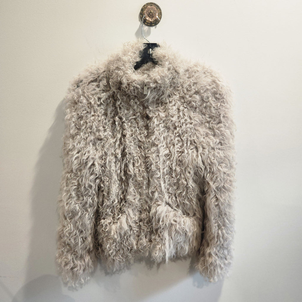 Lucille Golden Vintage, LLC IRO lamb fur zip-up jacket in a neutral shaggy curly texture on a hanger.