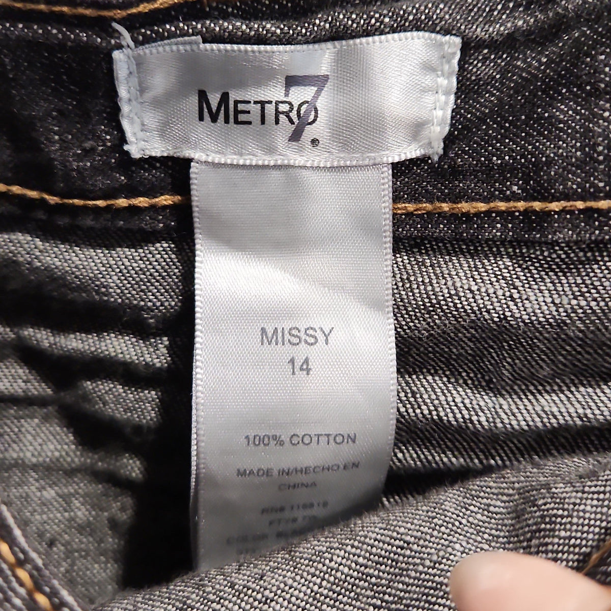 Lucille Golden Vintage, LLC Metro 7 dark wash denim skirt interior label showing 100% cotton material and size 14