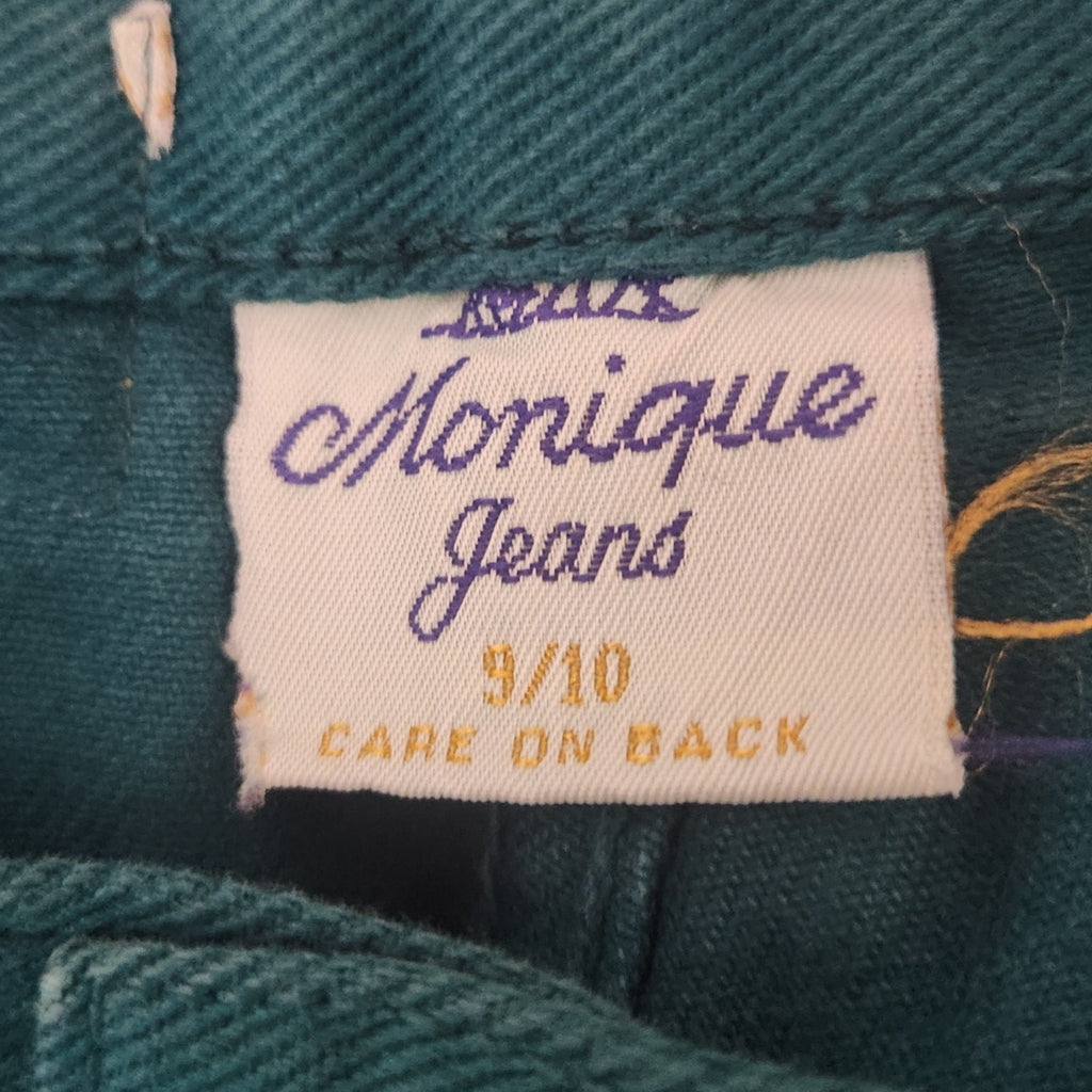 Lucille Golden Vintage, LLC Monique Jeans teal denim shorts interior size tag with purple branding and care label