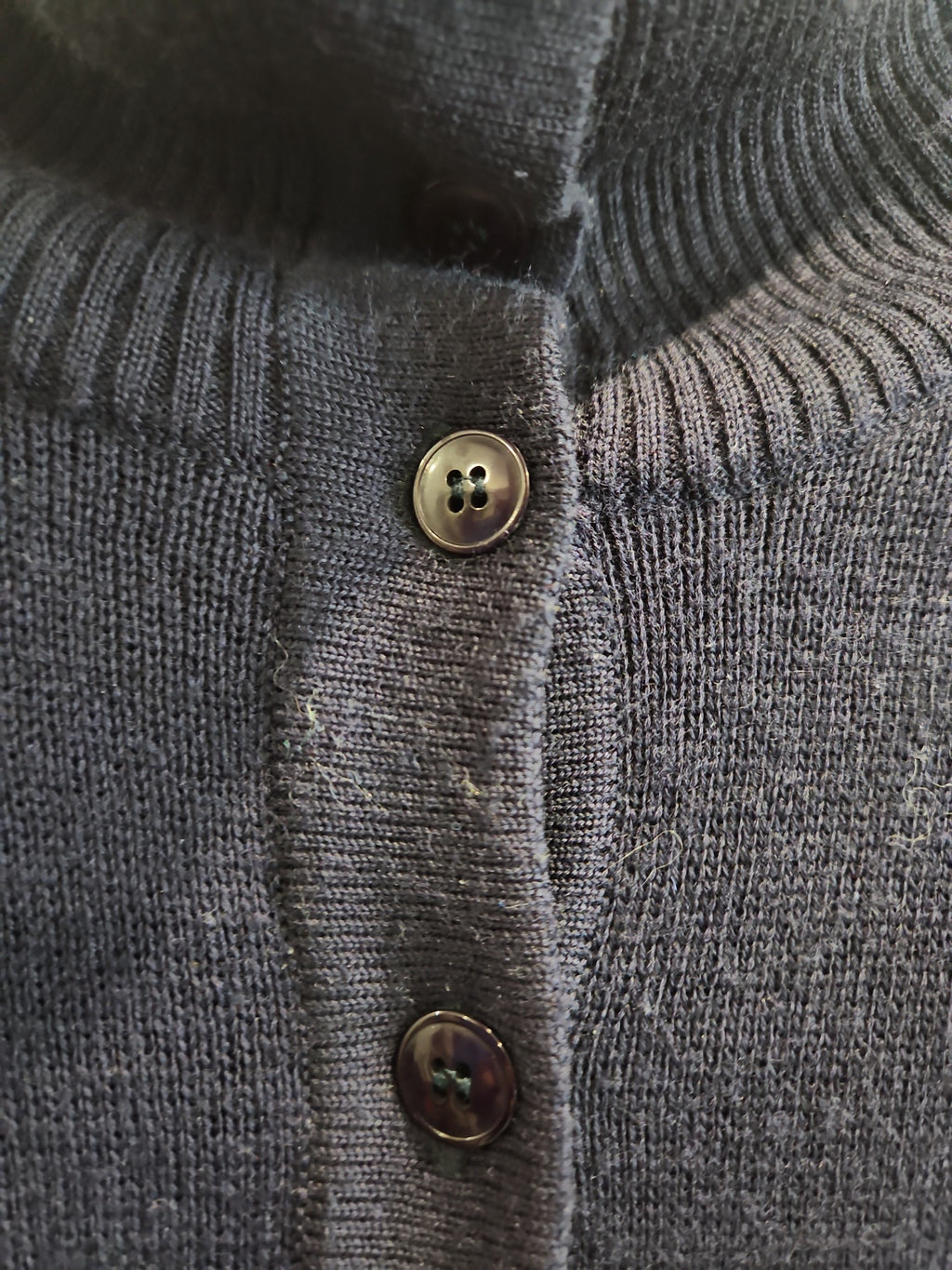Lucille Golden Vintage, LLC navy blue fine-knit mock neck cardigan with a button-down front and ribbed collar detail.