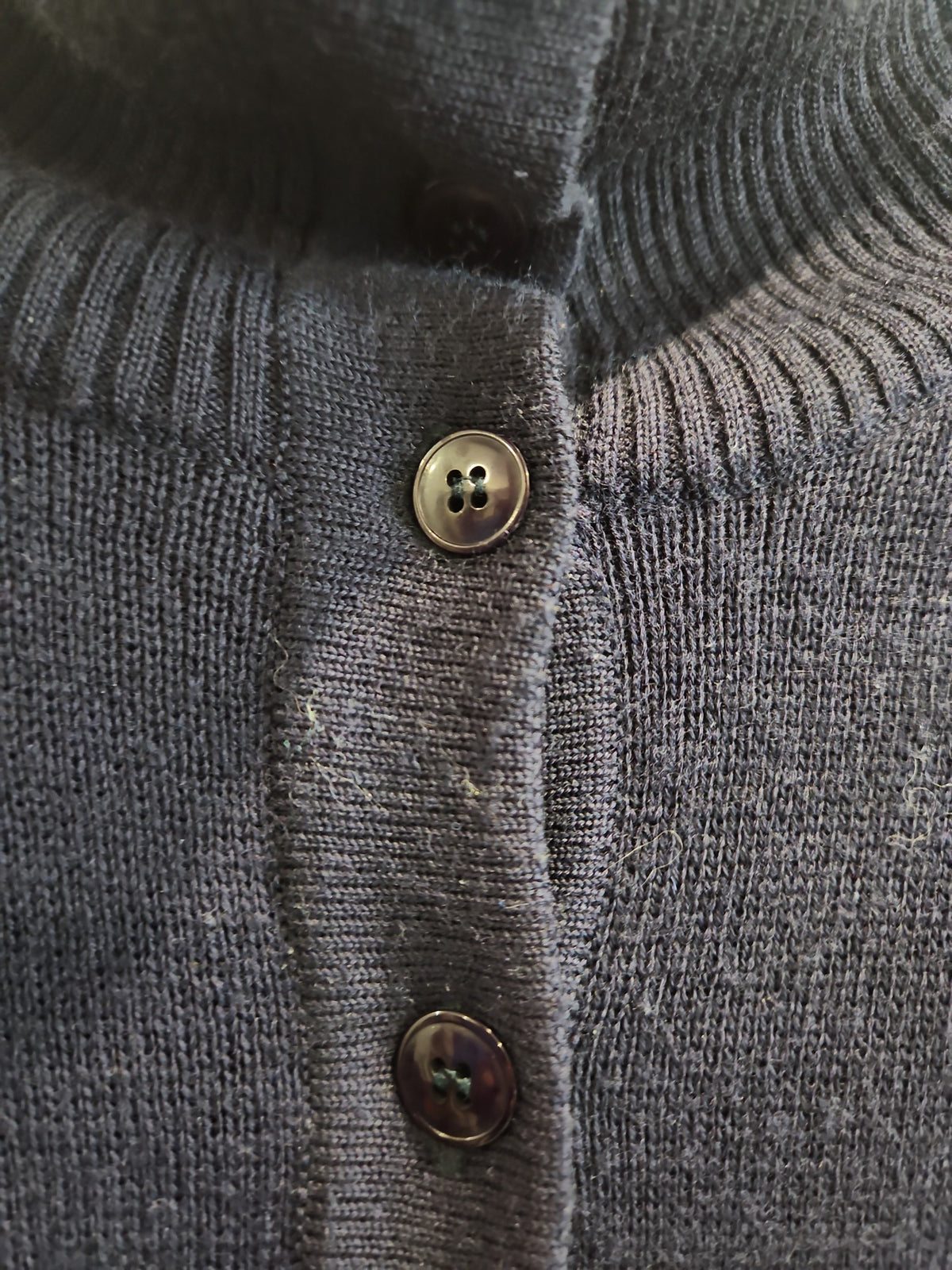 Lucille Golden Vintage, LLC navy blue fine-knit mock neck cardigan with a button-down front and ribbed collar detail.