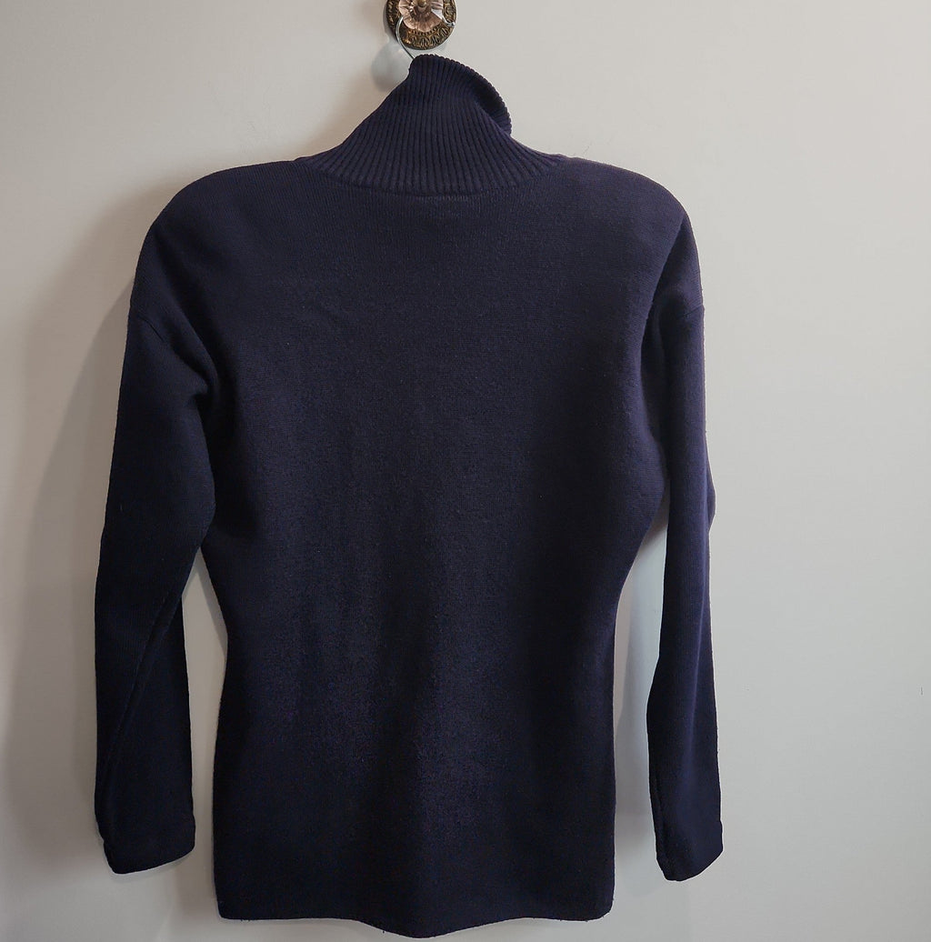 Lucille Golden Vintage, LLC navy blue mock neck long sleeve knit sweater hanging on a wall hook