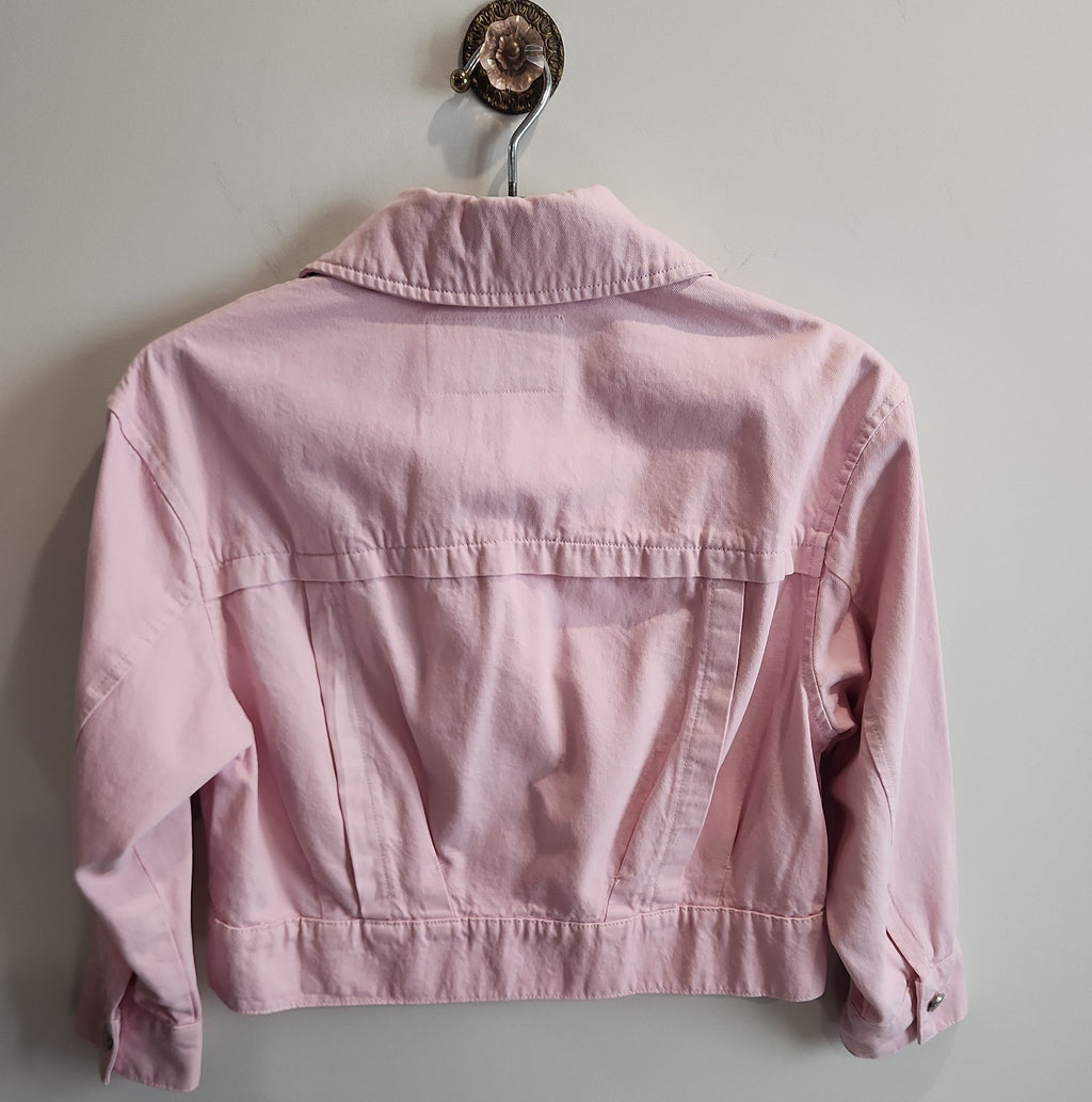 Back view of a Lucille Golden Vintage, LLC pastel pink cropped denim jacket with a structured collar and hem.