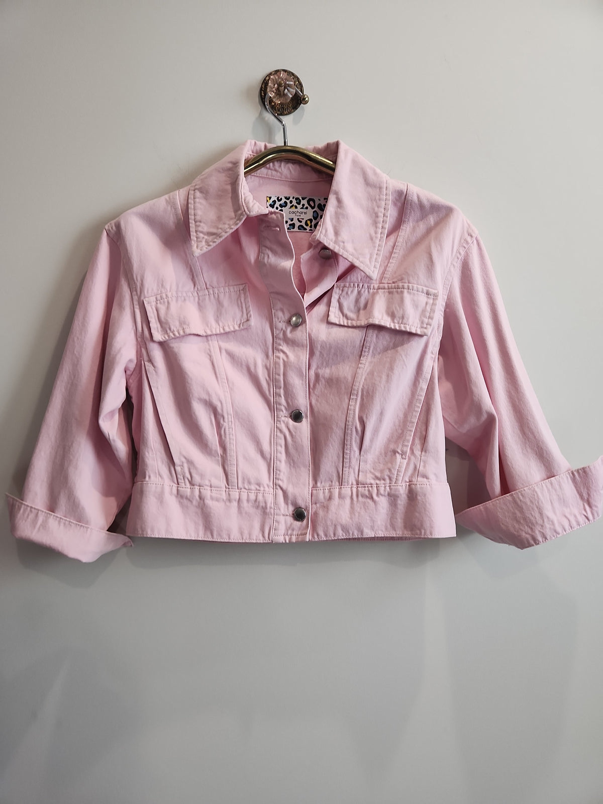 Lucille Golden Vintage, LLC pastel pink cropped denim jacket with button-front, chest pockets, and leopard print label