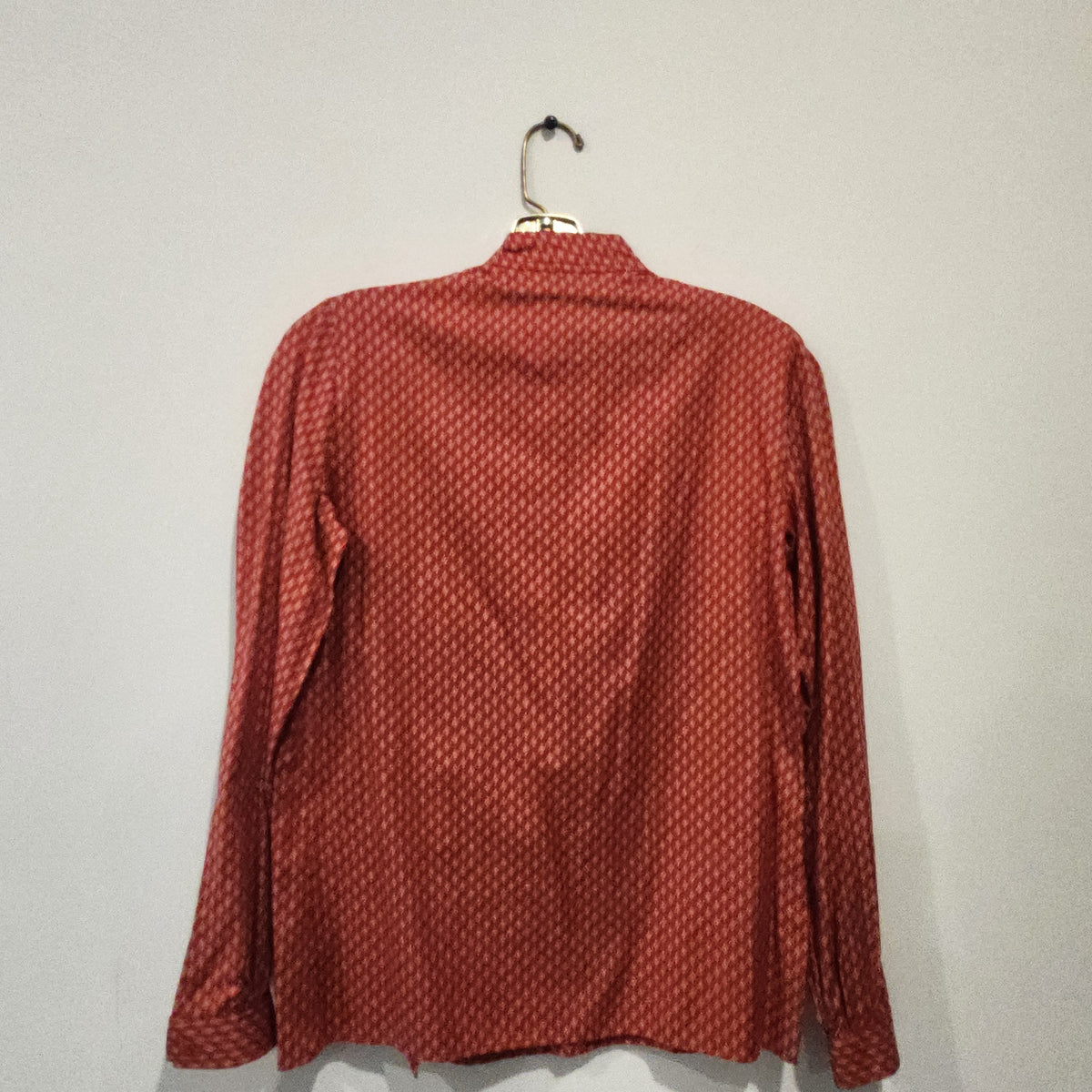 Back view of a Lucille Golden Vintage, LLC Jones New York long sleeve blouse with a red and cream chevron pattern.
