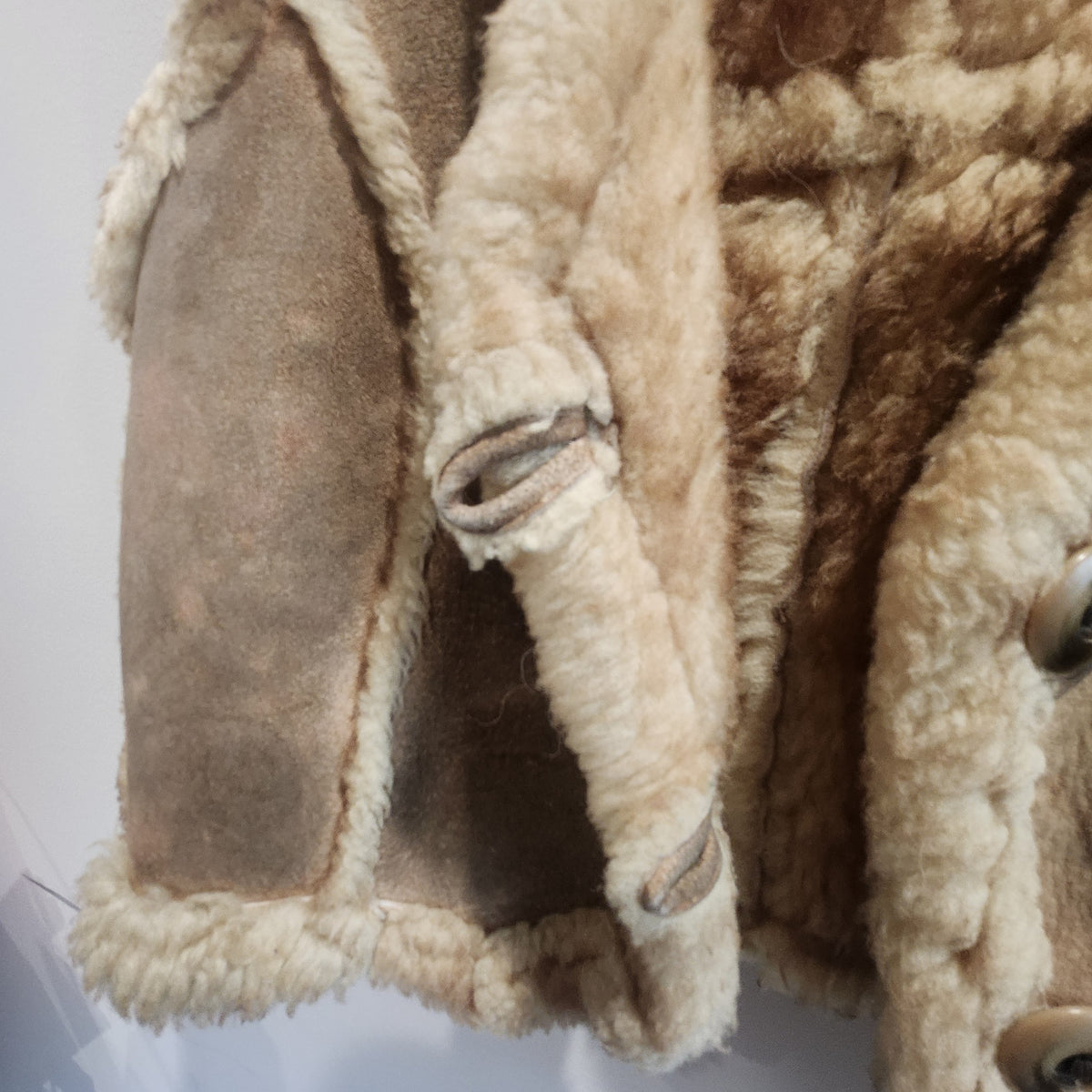 Lucille Golden Vintage, LLC tan suede vest with plush cream shearling lining and button-front closure detail