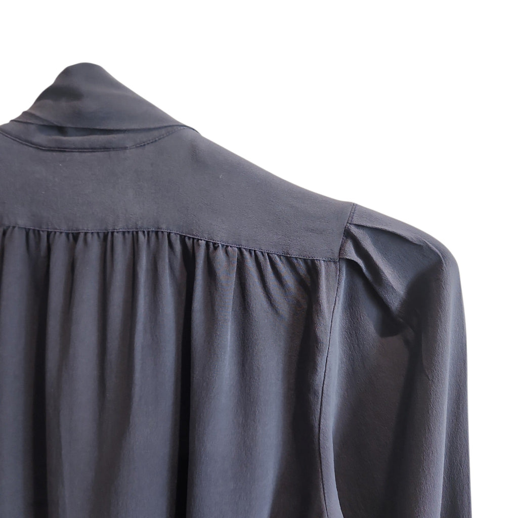 Lucille Golden Vintage, LLC slate-grey long sleeve blouse with gathered shoulders and pussy-bow neckline detail.